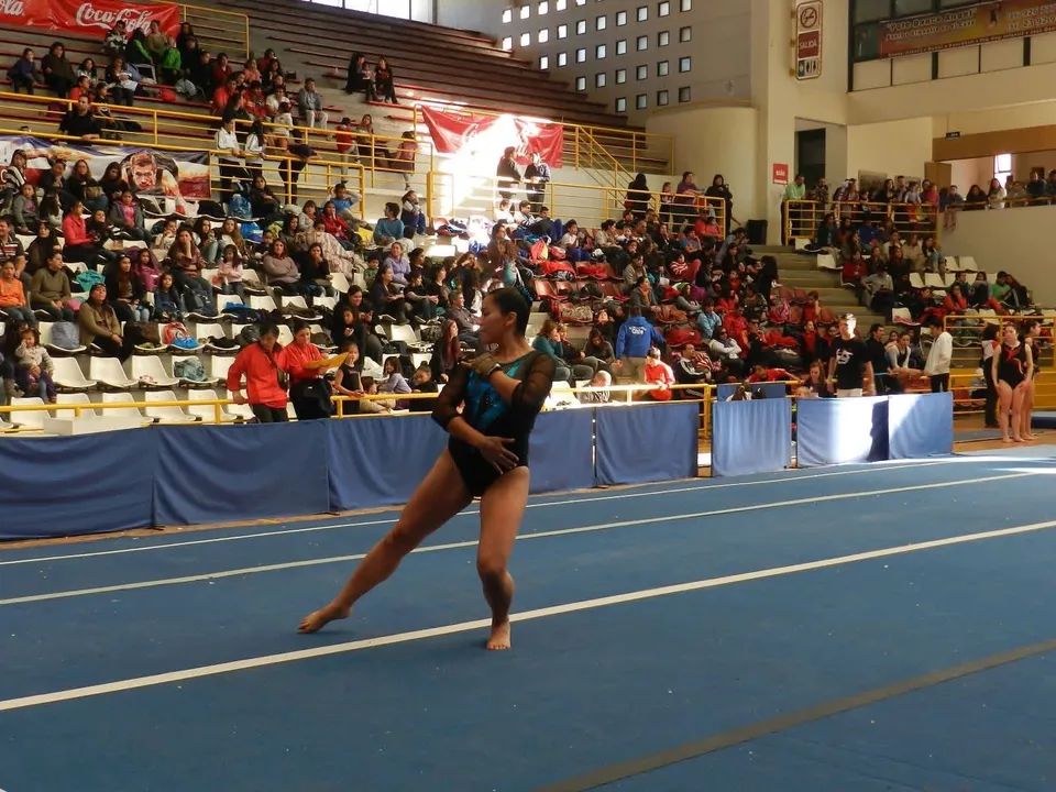 Gabriela competing in a floor routine at a gymnastics meet